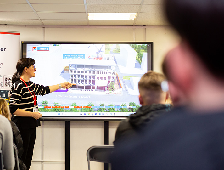 Surveyor delivering talk to students